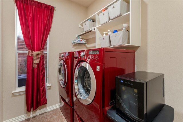 clothes washing area featuring light tile patterned flooring and washing machine and dryer