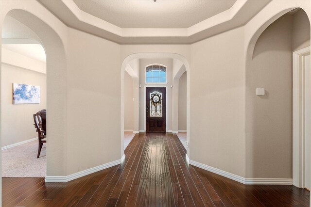 foyer with a textured ceiling and dark hardwood / wood-style floors