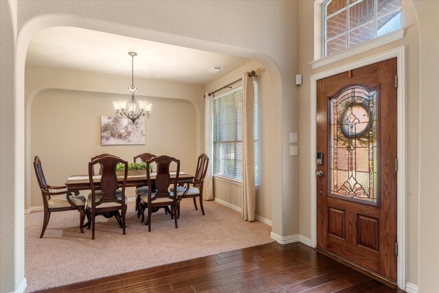 entryway featuring dark hardwood / wood-style floors and an inviting chandelier