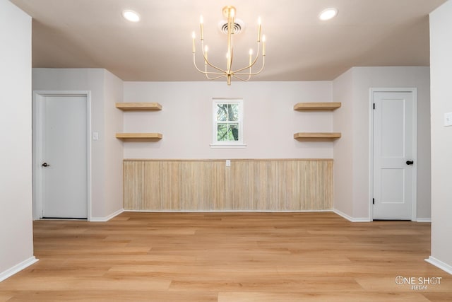 interior space featuring light wood-type flooring and a notable chandelier