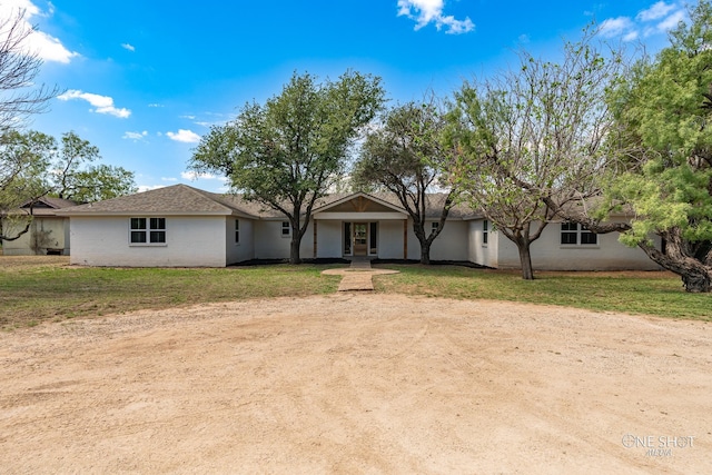 ranch-style home with a front lawn