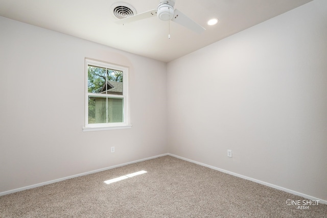 carpeted spare room featuring ceiling fan