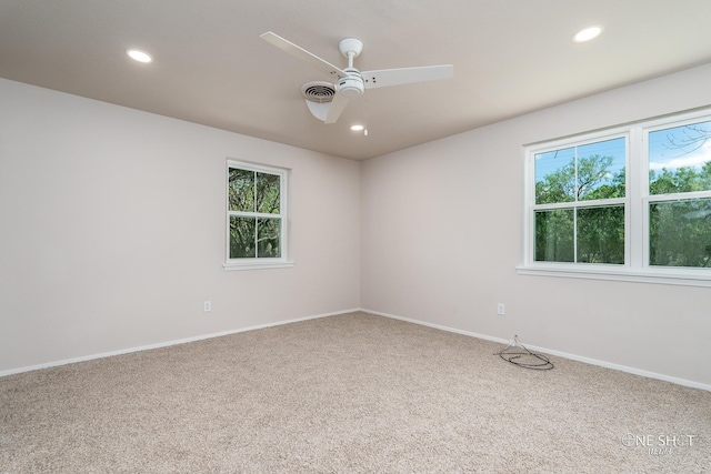 spare room featuring carpet and ceiling fan