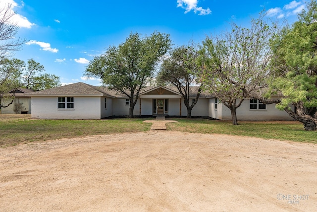 ranch-style home with a front lawn and brick siding