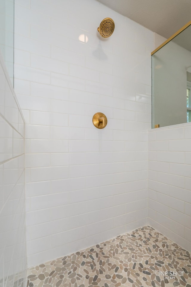 bathroom with tiled shower