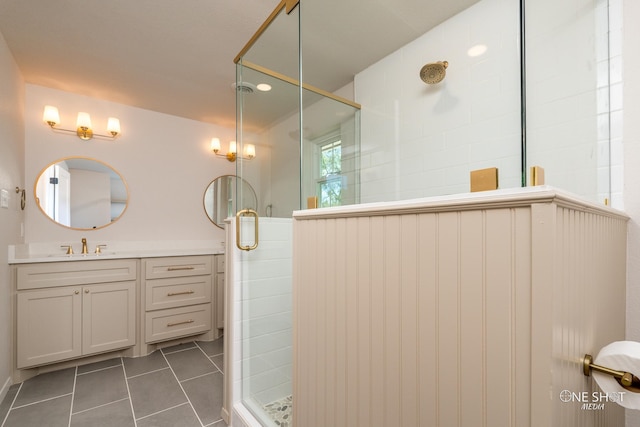 bathroom with walk in shower, vanity, and tile patterned floors