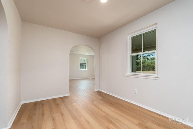 unfurnished room with light hardwood / wood-style flooring and a healthy amount of sunlight