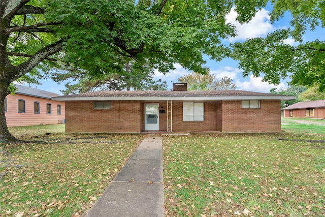 ranch-style home with a front lawn