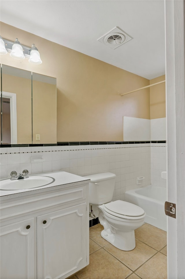 full bathroom featuring vanity, shower / bathtub combination, tile patterned floors, tile walls, and toilet