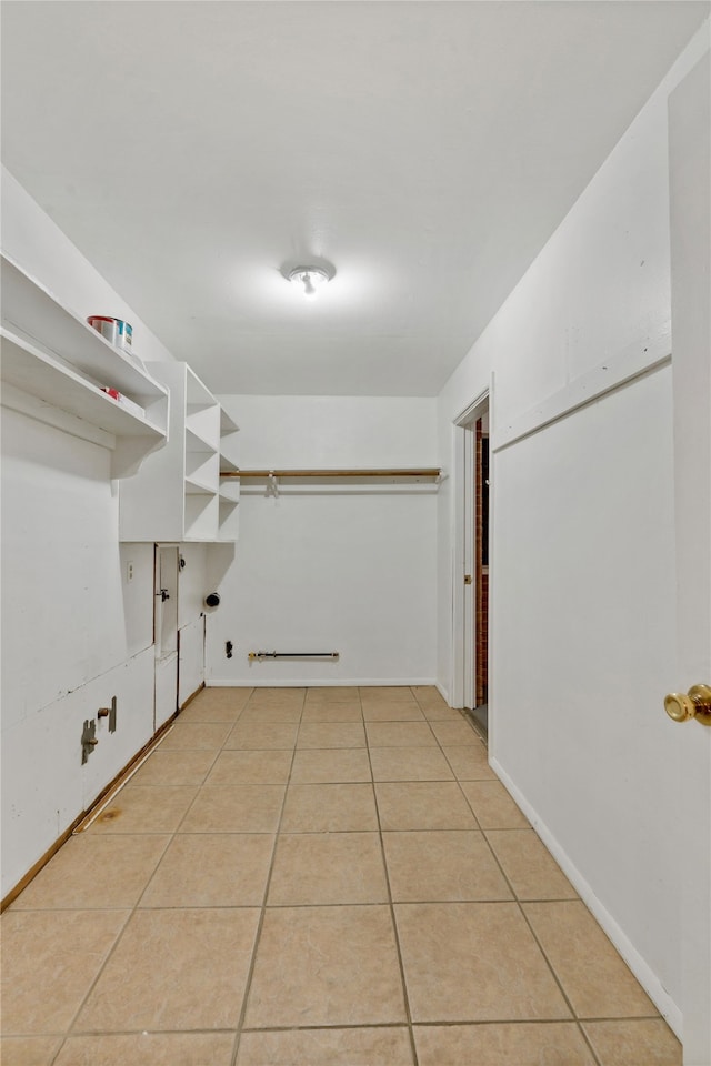 walk in closet with light tile patterned flooring