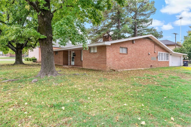 view of side of property with a lawn and a garage