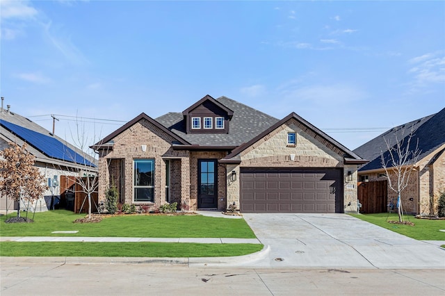 view of front of house featuring a garage and a front lawn