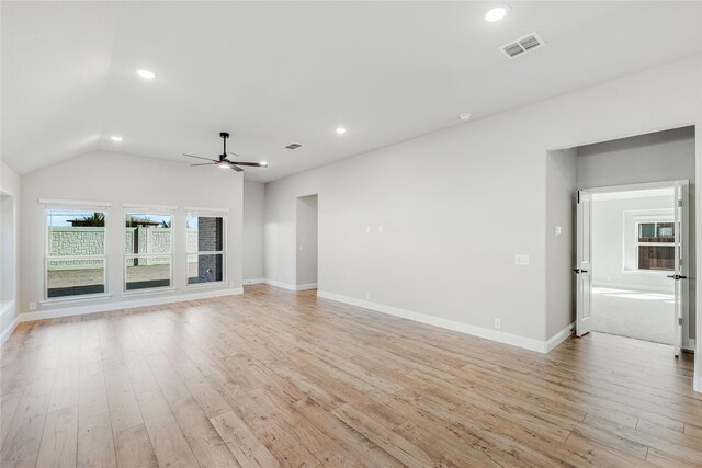 unfurnished living room with vaulted ceiling, ceiling fan, and light hardwood / wood-style floors