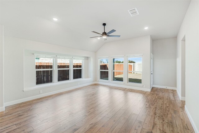 spare room featuring lofted ceiling, carpet floors, ceiling fan, and a wealth of natural light