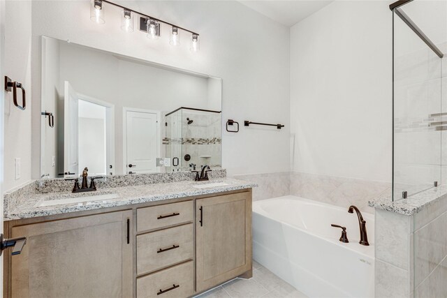 bathroom featuring vanity, tile patterned flooring, and separate shower and tub