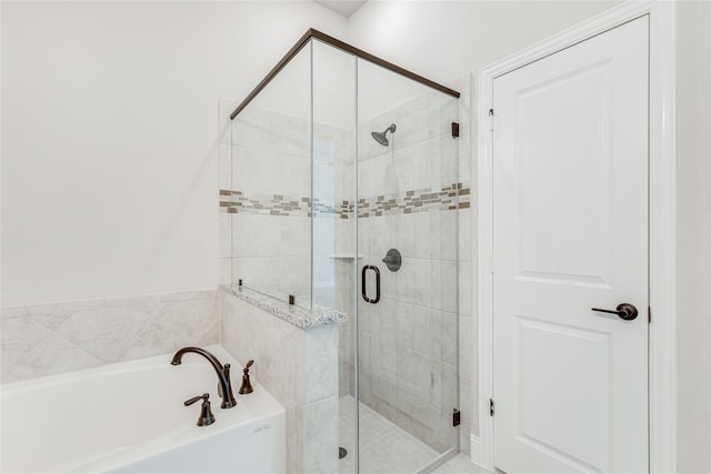 bathroom featuring shower with separate bathtub