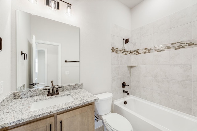 full bathroom with toilet, tiled shower / bath combo, and vanity