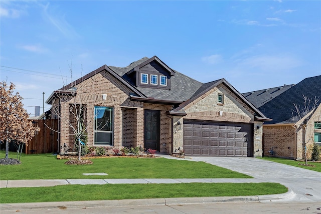 view of front of property featuring a front lawn and a garage