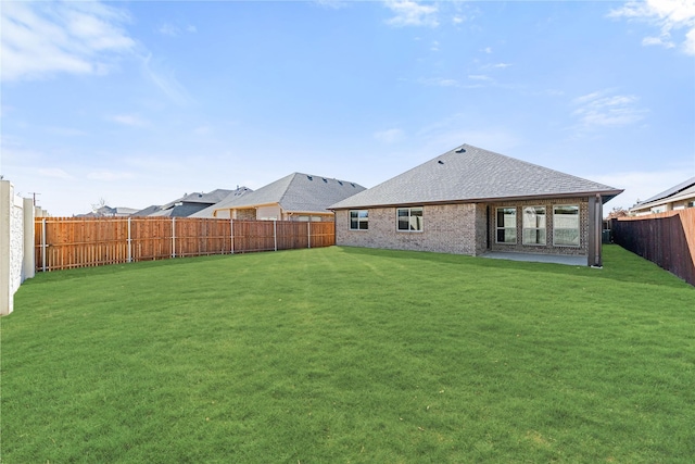 rear view of property with a lawn and a patio area