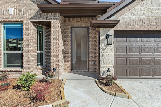 view of exterior entry with a garage