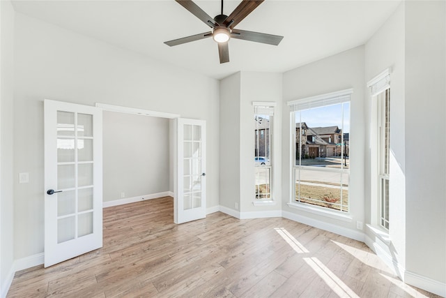 unfurnished room featuring french doors, light wood-type flooring, and a wealth of natural light