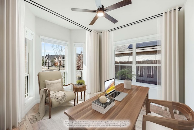 sitting room with ceiling fan and light wood-type flooring