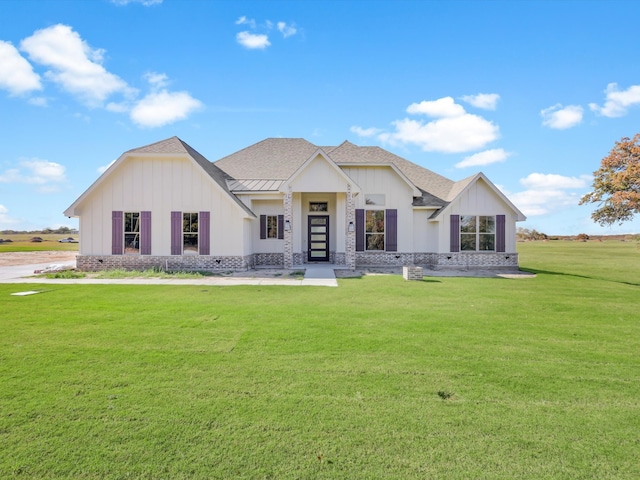 modern farmhouse style home with a front lawn