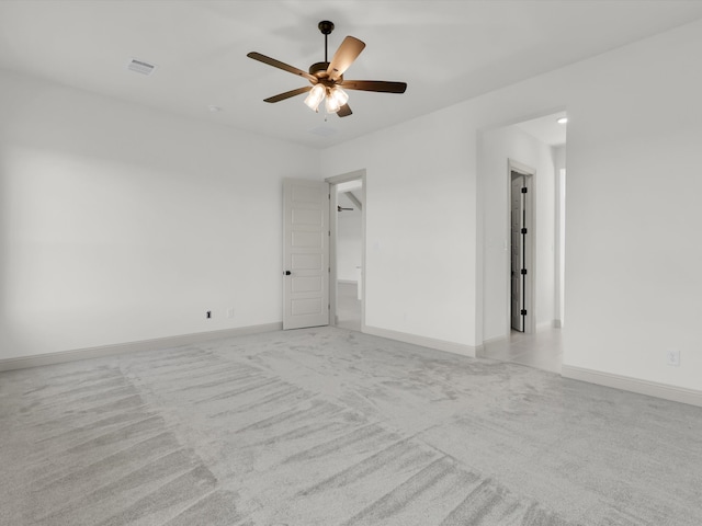 carpeted spare room with ceiling fan