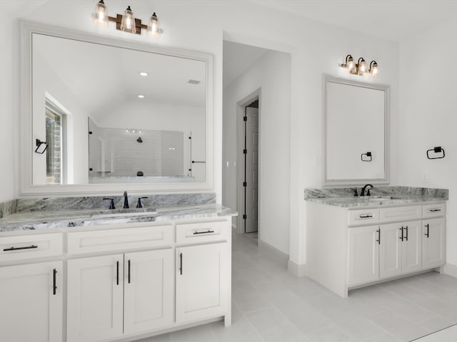 bathroom featuring tile patterned floors, vanity, lofted ceiling, and walk in shower