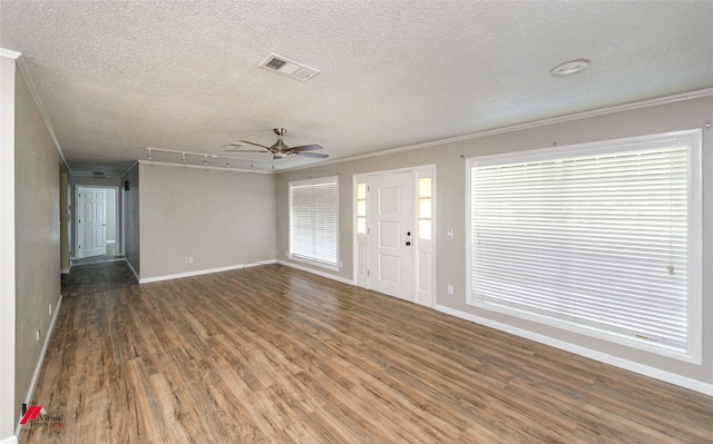 interior space with ceiling fan, a textured ceiling, dark wood-type flooring, and a wealth of natural light