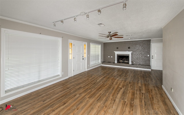 unfurnished living room featuring brick wall, a brick fireplace, a textured ceiling, ceiling fan, and dark hardwood / wood-style floors