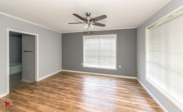 spare room with a textured ceiling, crown molding, ceiling fan, and hardwood / wood-style flooring