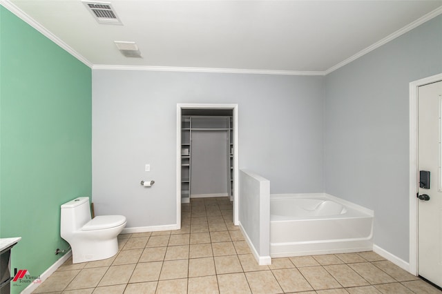 bathroom featuring a washtub, tile patterned floors, crown molding, vanity, and toilet