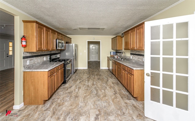 kitchen with backsplash, sink, light hardwood / wood-style flooring, and stainless steel appliances