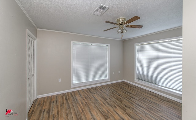 spare room with a textured ceiling, ceiling fan, dark hardwood / wood-style floors, and crown molding