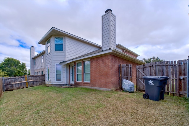 back of house with a lawn