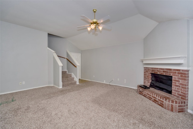 unfurnished living room with carpet, vaulted ceiling, ceiling fan, and a fireplace