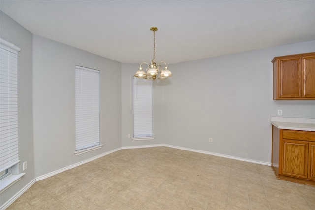 unfurnished dining area with an inviting chandelier