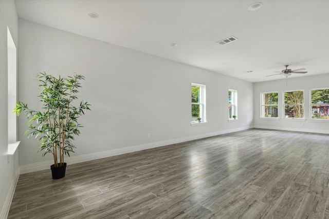 spare room featuring ceiling fan and dark hardwood / wood-style floors