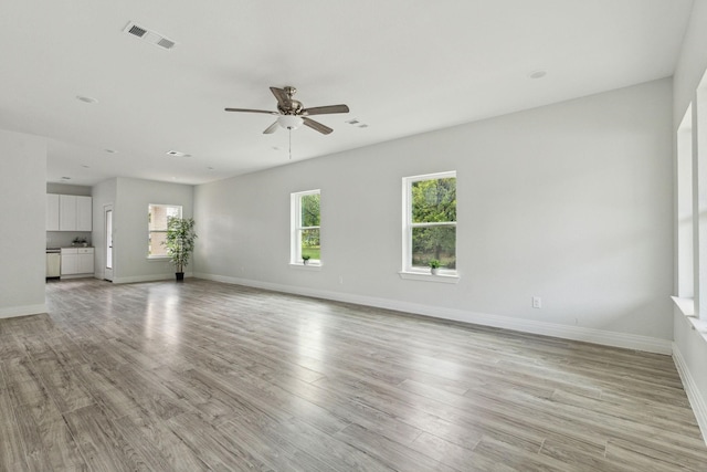 unfurnished living room with light hardwood / wood-style flooring, ceiling fan, and plenty of natural light