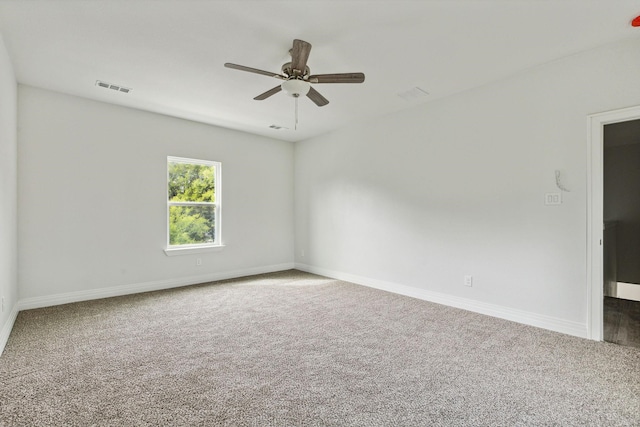 carpeted empty room featuring ceiling fan