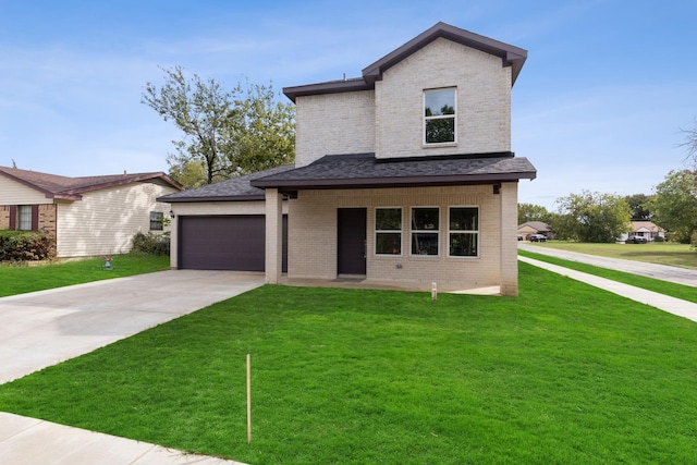 view of front of house with a garage and a front yard