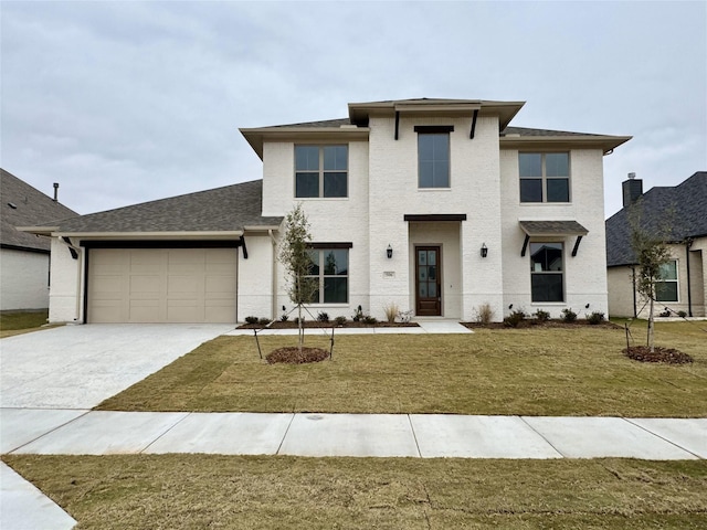 view of front of house with a front yard and a garage