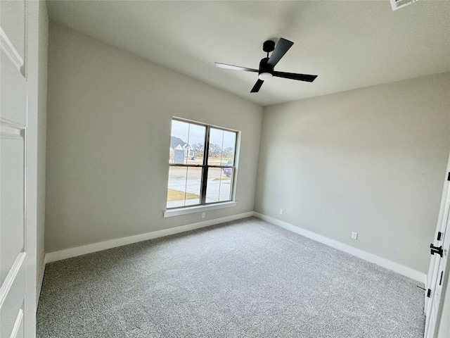 empty room featuring carpet flooring and ceiling fan