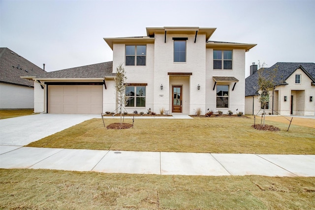 view of front of property with a garage and a front lawn