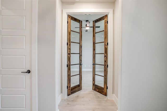 corridor with light hardwood / wood-style flooring