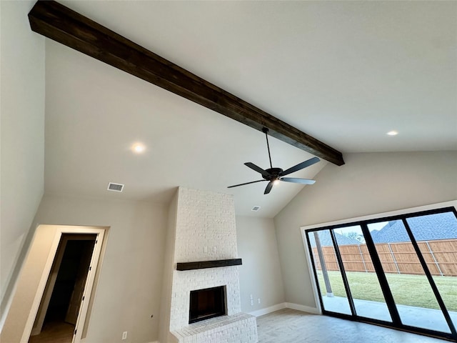 unfurnished living room featuring vaulted ceiling with beams, ceiling fan, and a fireplace