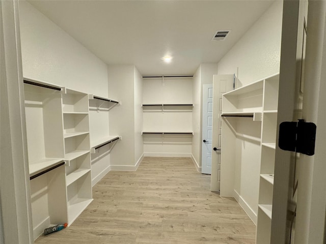 spacious closet featuring light wood-type flooring