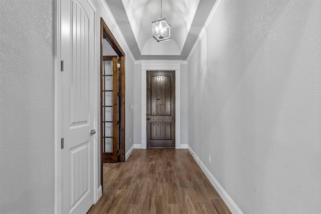 interior space featuring dark hardwood / wood-style flooring, ornamental molding, and a chandelier