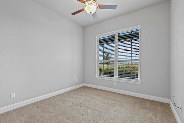 carpeted spare room featuring ceiling fan